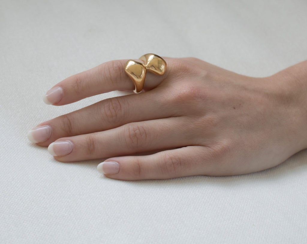 Bold chunky gold Lulu double ball ring featuring two statement spheres, perfect for making a striking fashion statement.