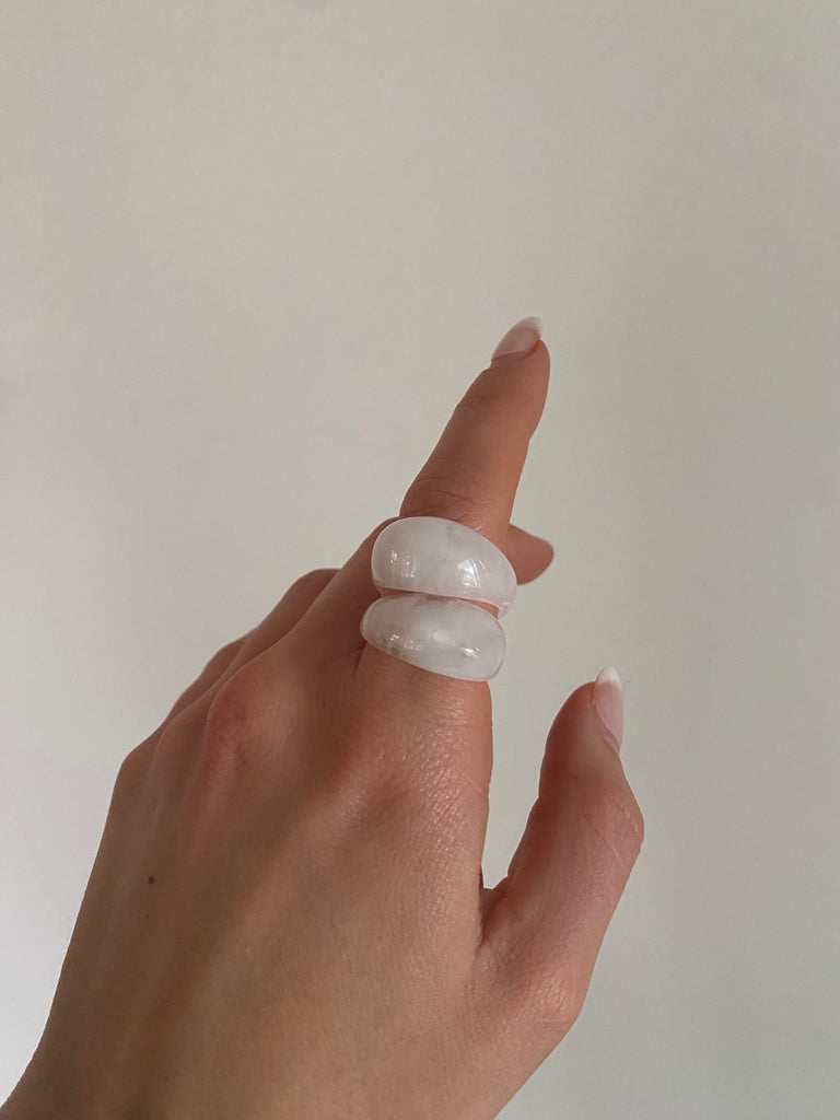 White marble ring with a polished finish, showcasing a sleek and modern design. Perfect for a stylish jewelry collection.